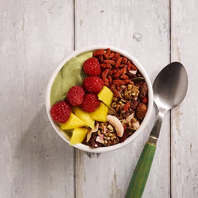 Vanda's Allergen free colorful smoothie bowl with berries, mango, and Vanda's homemade granola.